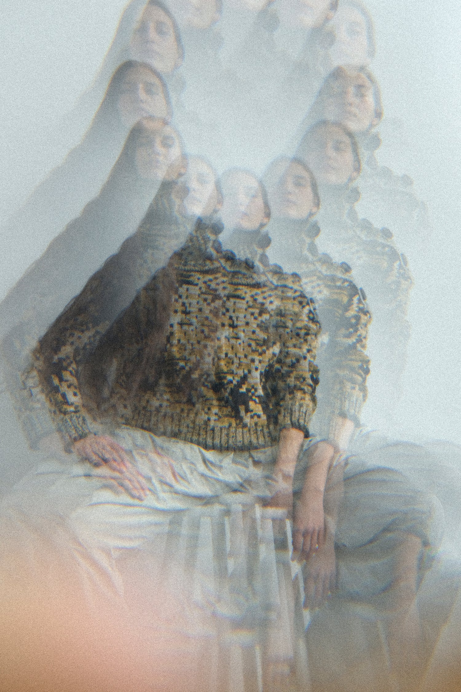 Woman in a wearing pieces from the Veronique Leroy FW25 collection with a distorted filter, sitting on a stool.