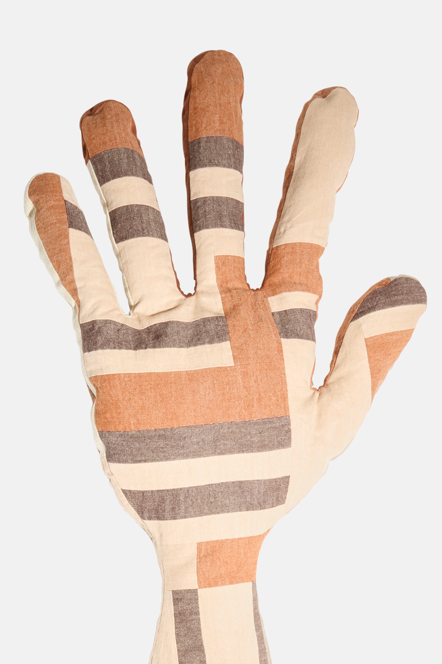 The Sonia Delaunay Tissu Simultané Giant Hand Bolster II by Wiener Times is an Austrian-made hand-shaped pillow with brown, beige, and gray stripes on a white background, inspired by the Wiener Werkstätte.