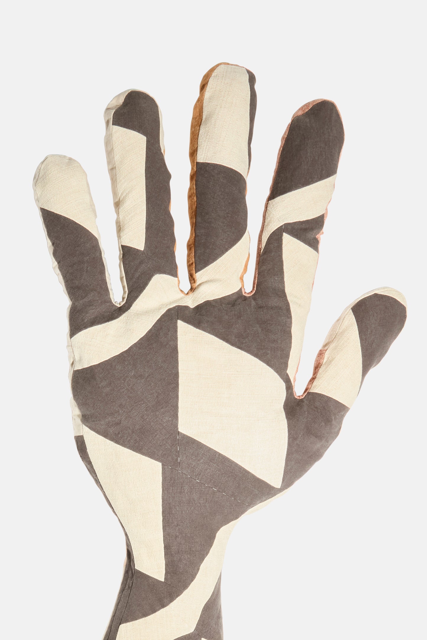 The Wiener Times Sonia Delaunay Tissu Simultané Giant Hand Bolster I is a hand-shaped pillow with a geometric beige, white, and gray design inspired by Wiener Werkstätte, shown on a plain white background. Made in Austria.