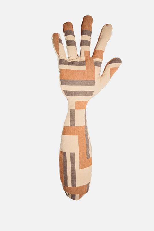 The Sonia Delaunay Tissu Simultané Giant Hand Bolster II by Wiener Times is a hand-shaped pillow, made in Austria, featuring a geometric beige, brown, and gray pattern on white inspired by the Wiener Werkstätte.