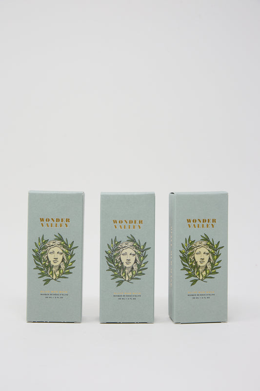 Three boxes labeled "Wonder Valley Olive Mud Mask" with the illustration of a woman's face surrounded by leaves on a white background.