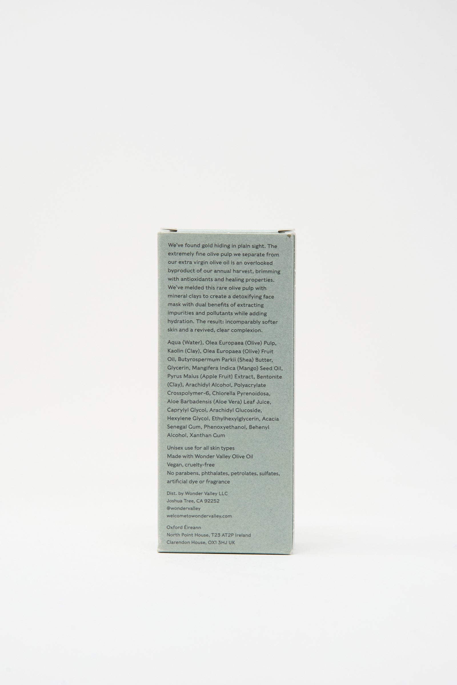 The back of the Wonder Valley Olive Mud Mask box features a light gray-green color with small black text listing ingredients and product details. This mask hydrates, balances skin, and helps prevent breakouts.