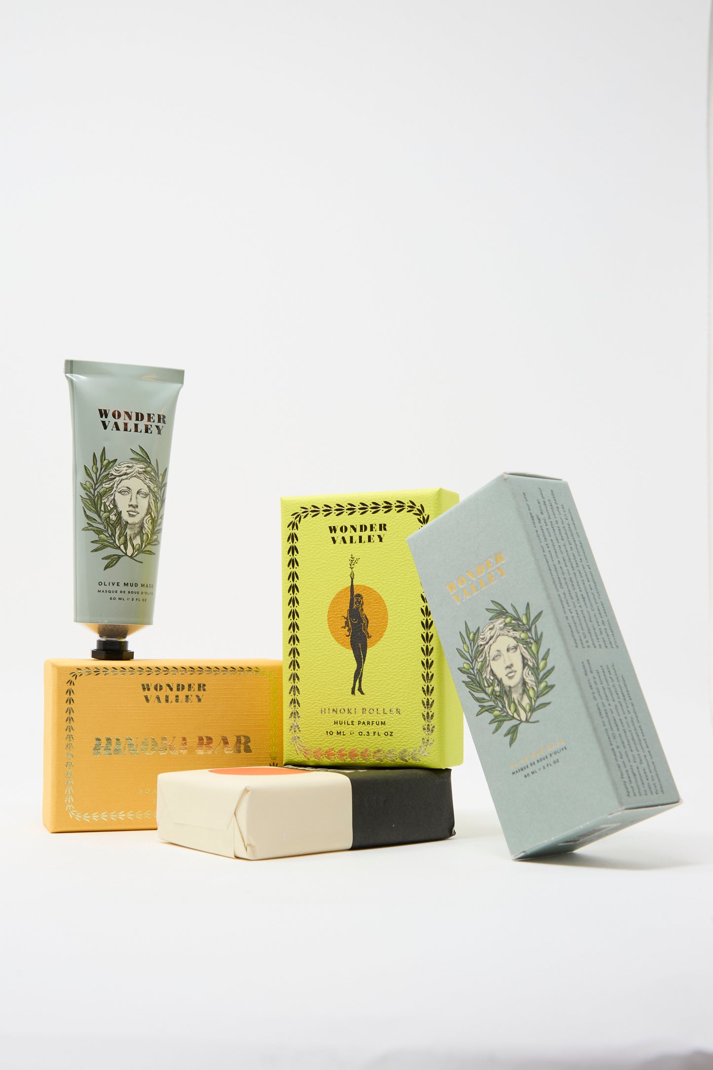 A selection of Wonder Valley skincare, including the Olive Mud Mask for hydrated, balanced skin, plus a tube, two boxes, and three soap bars, all displayed against a white background.