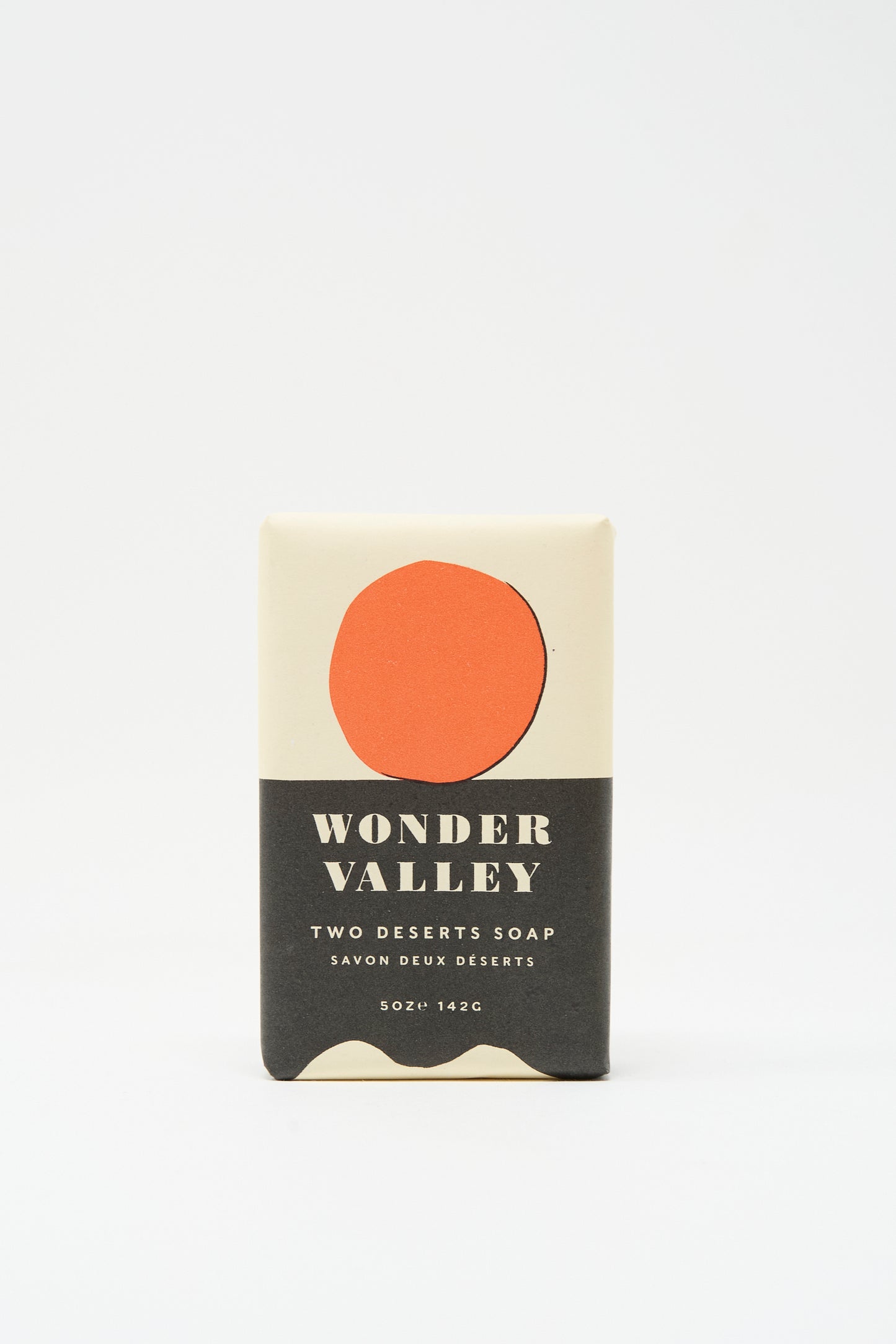 Wonder Valley’s Two Deserts Soap is a plant-based bar soap made with Wonder Valley Olive Oil, packaged in minimalist beige wrapping with a red circle and black text.