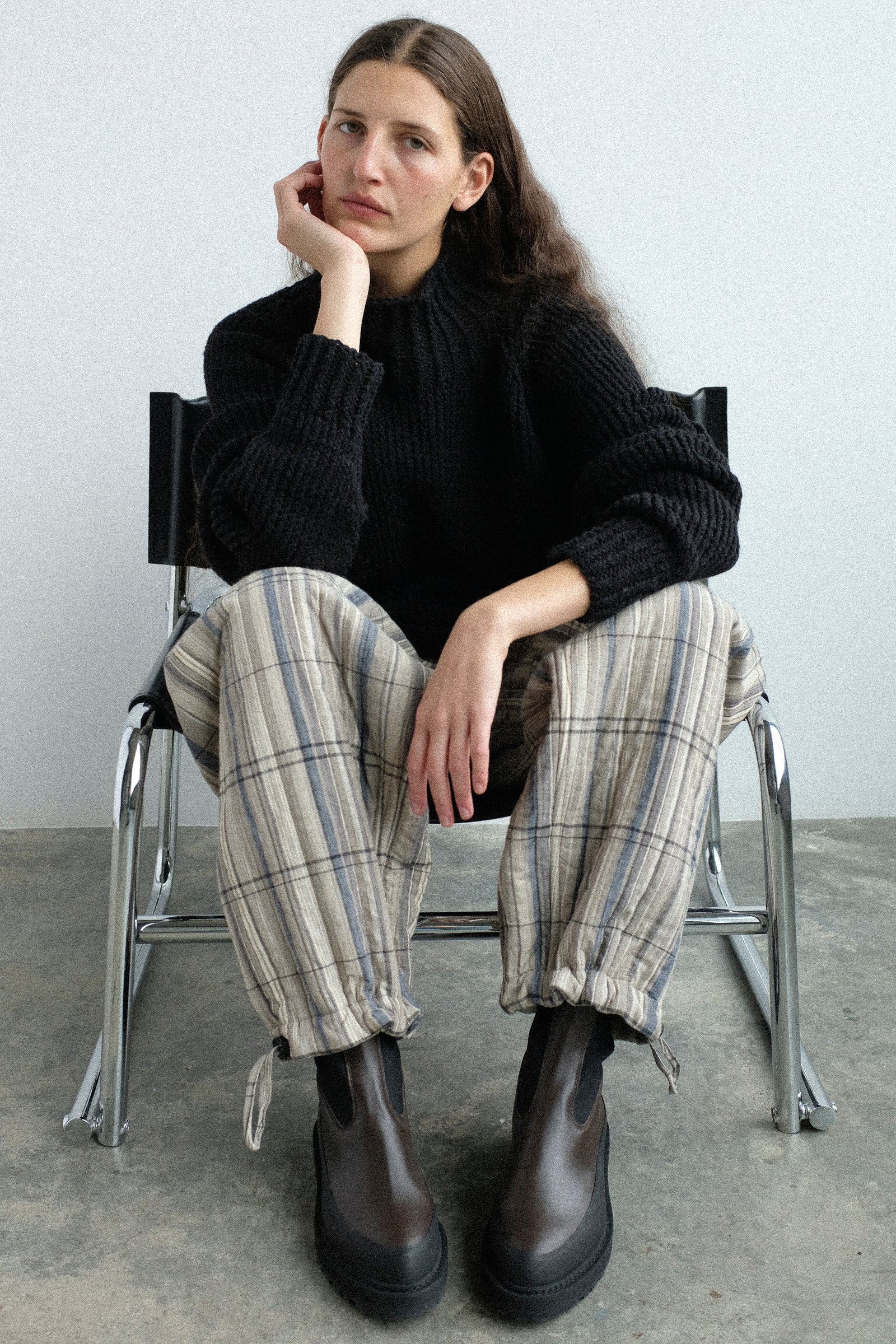 Woman sitting on a chair wearing pieces from the Jan-Jan Van Essche collection.