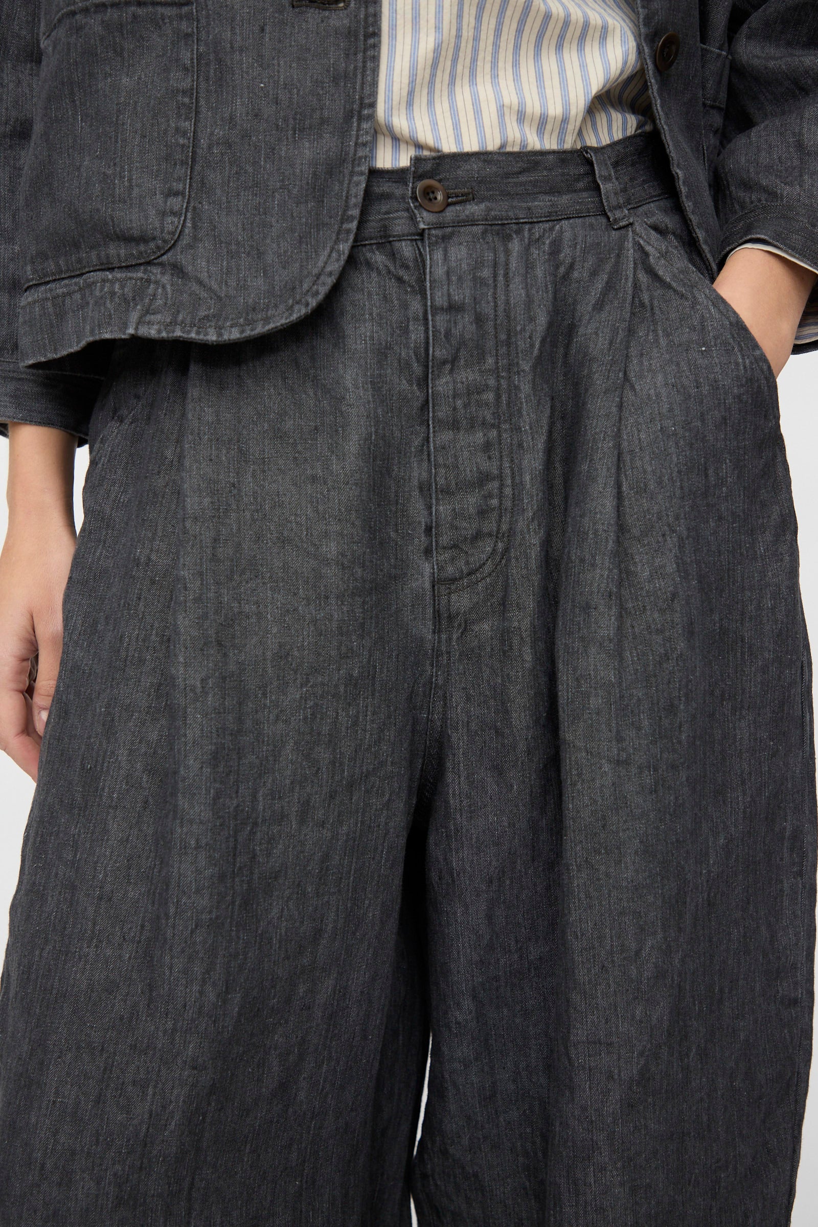 Model wears nest Robe's Linen Denim Wide Pants in Black, styled high-waisted and wide-leg with a matching jacket over a striped shirt; shown from waist to mid-thigh.