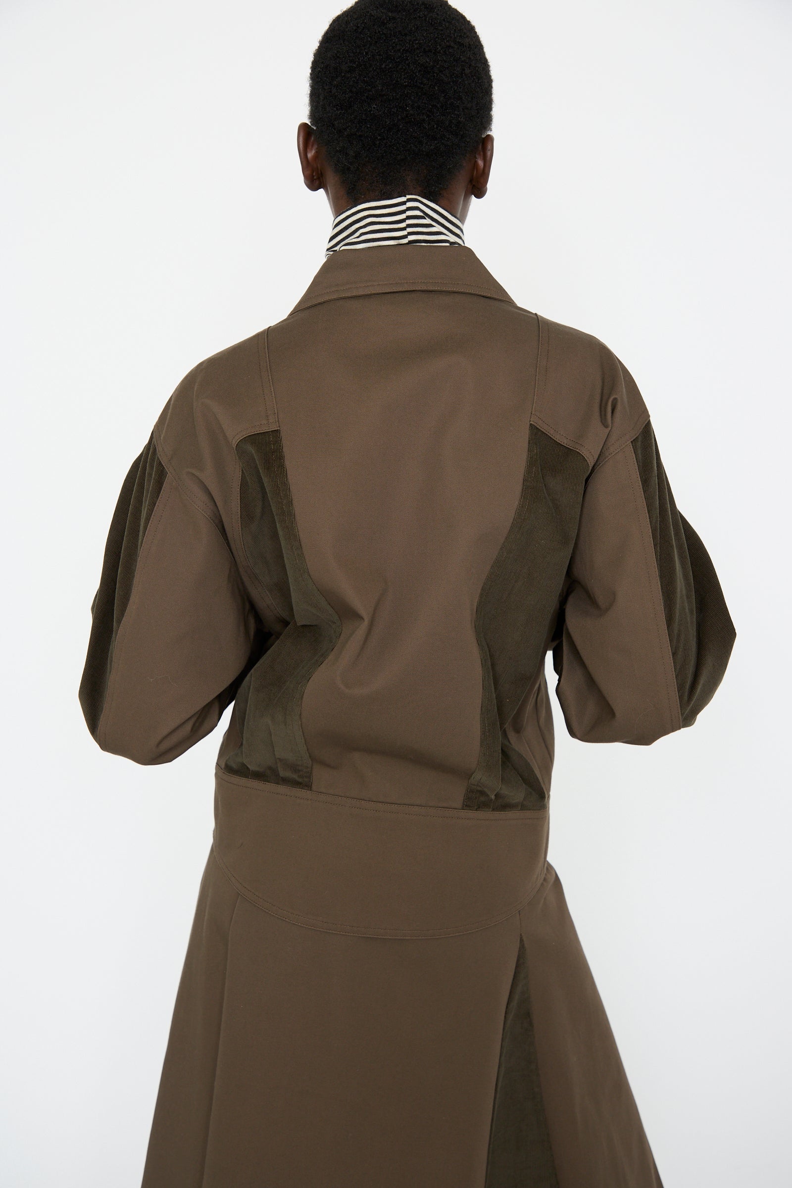 A woman is seen from behind wearing the Cotton Twill Coda Jacket in Beam by SC103, set against a plain white background.