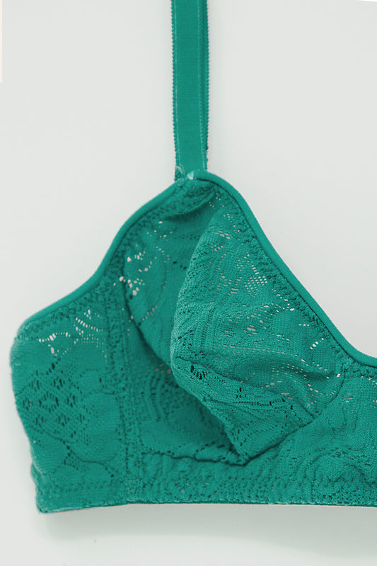 A close up of a Tamara Bralette in Emerald by Araks with lace on it.
