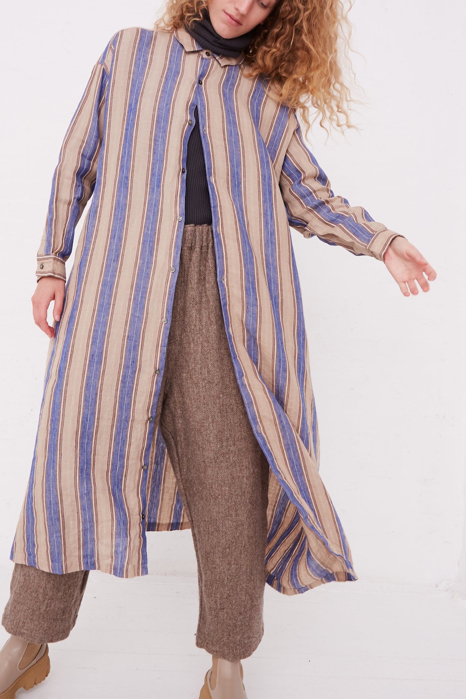 A woman wearing an Ichi Antiquités Linen Stripe Dress in Blue.