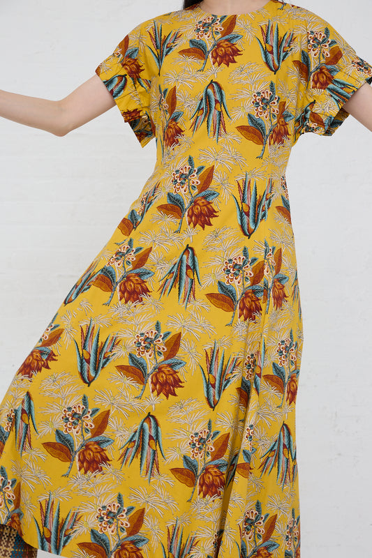 A woman wearing the Ulla Johnson Devon Dress in Marigold. Up close and front view.