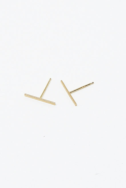 A pair of Kathleen Whitaker Staple Stud 1/2" Single Earrings in 14K Yellow Gold on a white surface.
