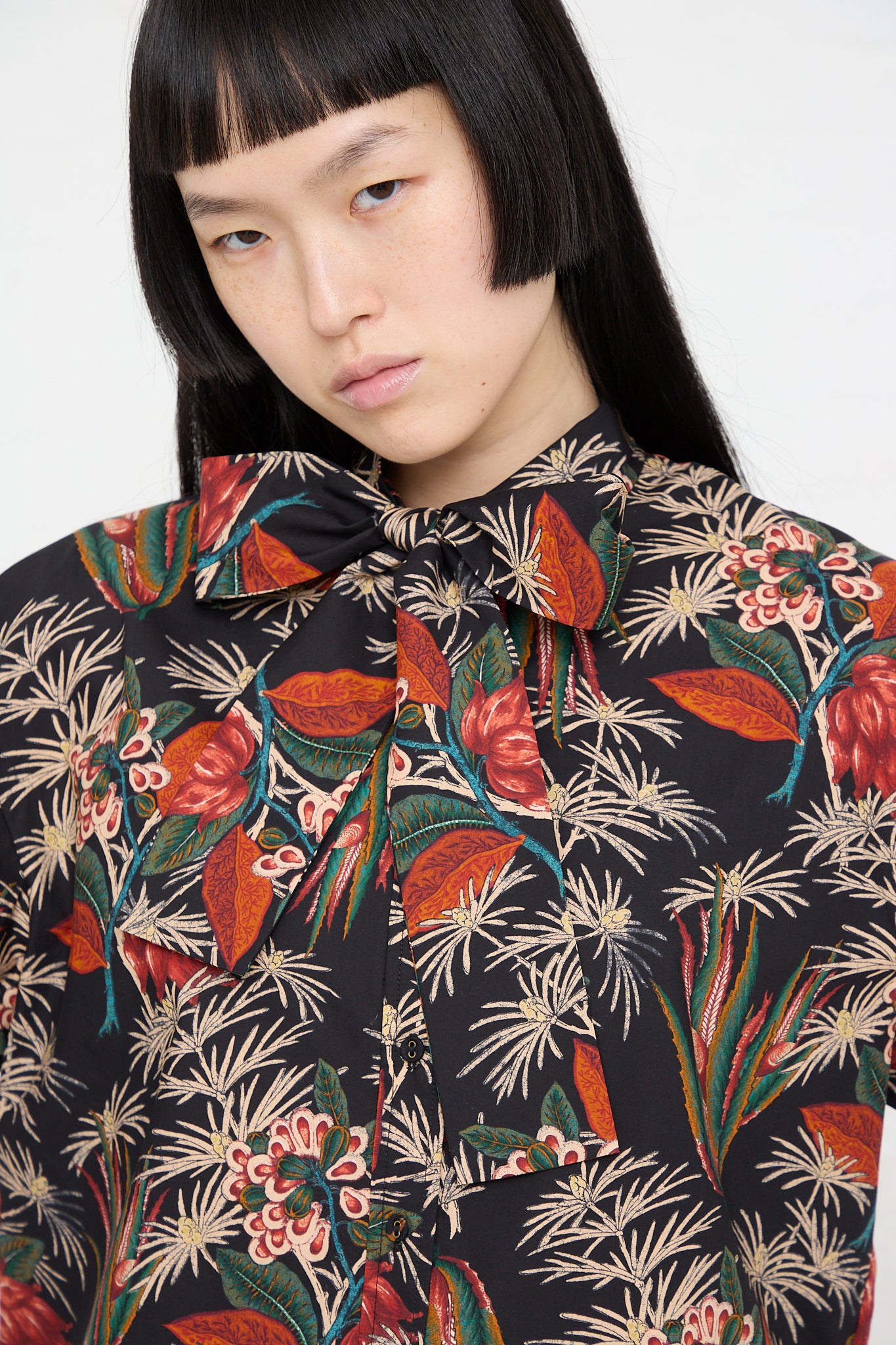 A model wearing an Ulla Johnson Alberta Blouse in Anthurium with a floral print. Front and up close view.