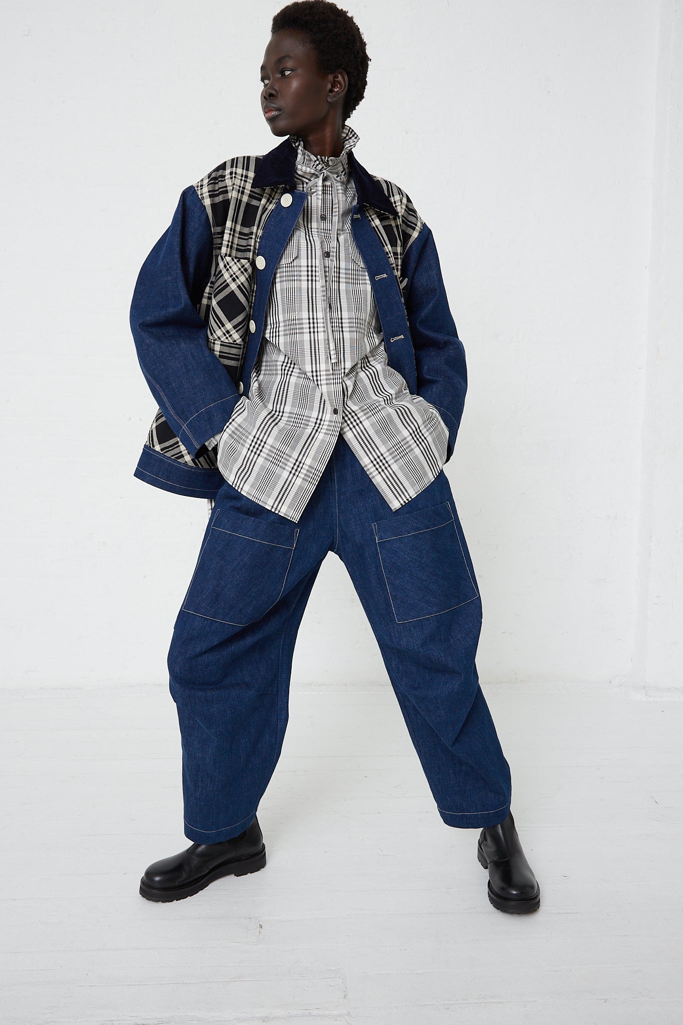 A woman in a plaid jacket and Japanese Denim Pant with Front Patch Pockets by KasMaria posing for a photo.