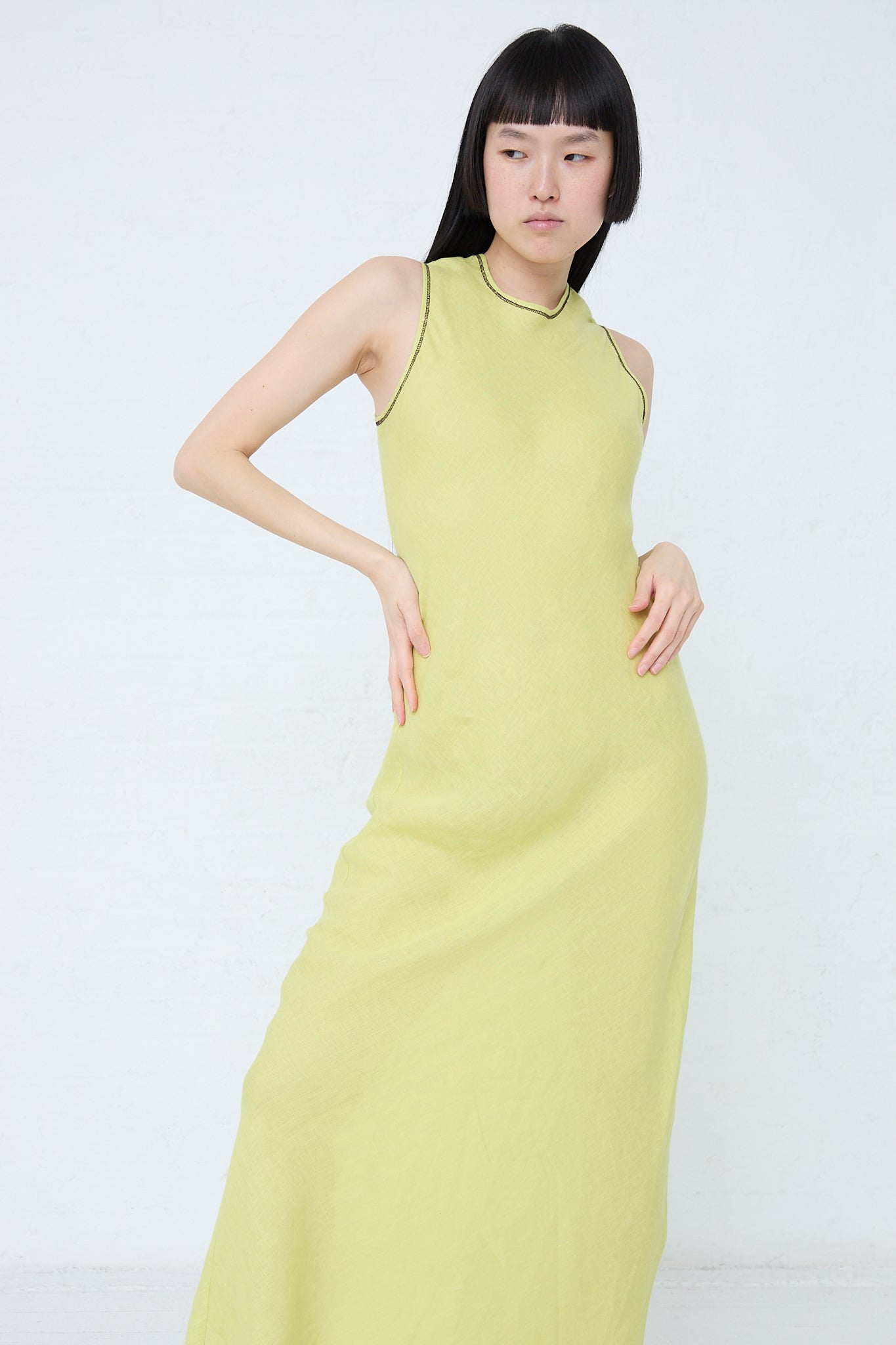 The model is wearing a Baserange Linen Dydine Tank Dress in Lime (Green).