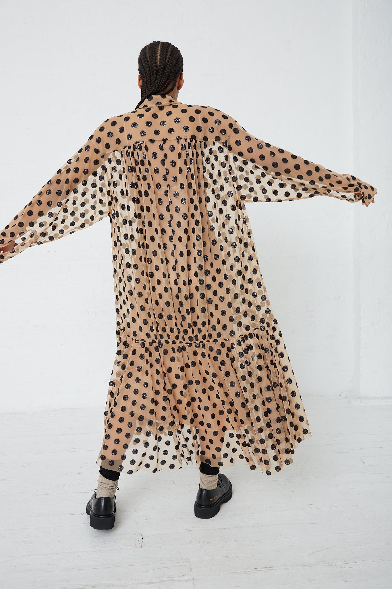 A woman in a Rachel Comey Sequin Dots Tulle Lanza Dress in Nude. Back view and full length.