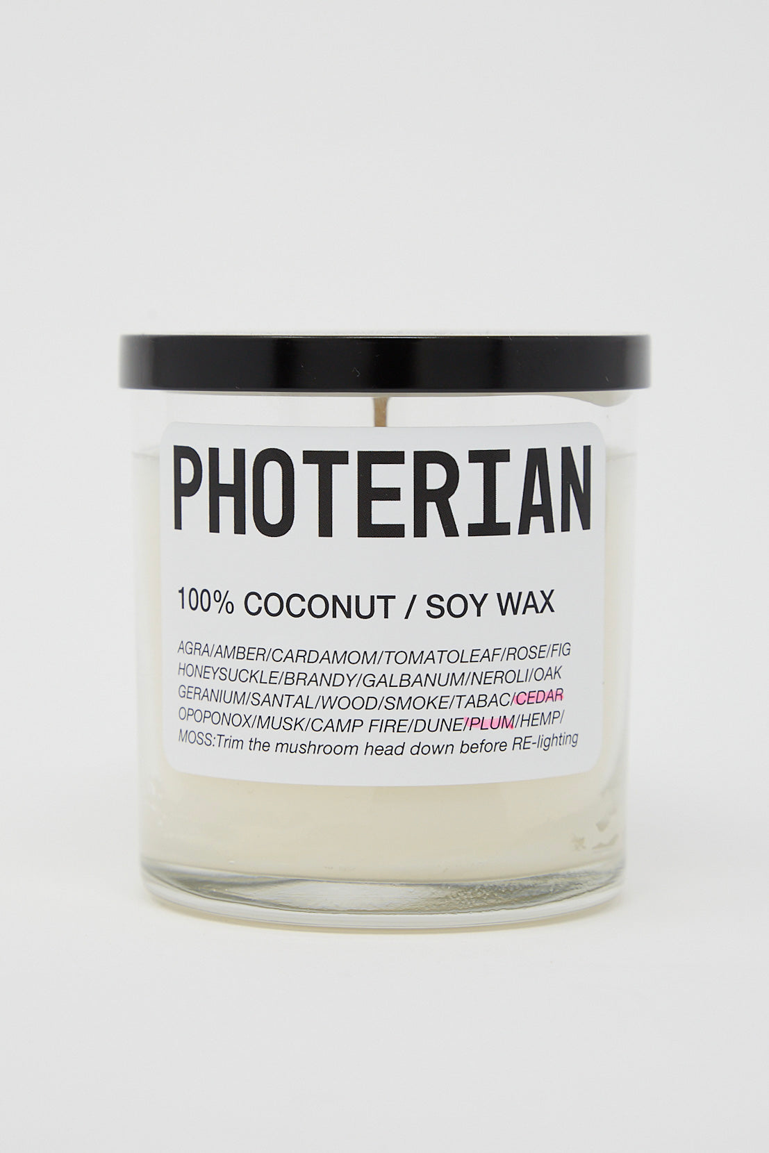 A Votive Coconut Soy Candle in Plum Cedar with the brand name Photerian, made from a coconut and soy blend.