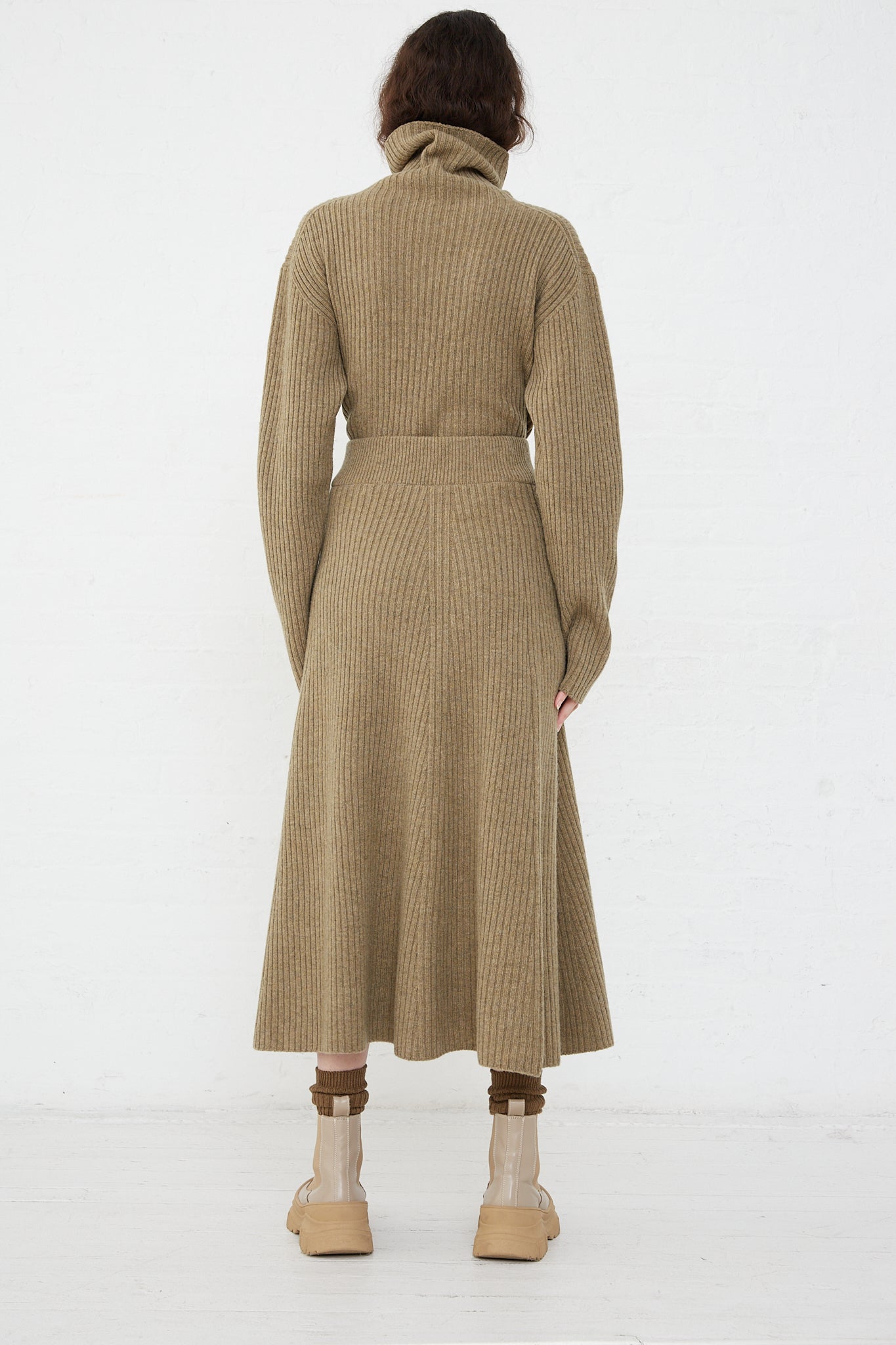 The back view of a woman wearing an Ichi Antiquités Wool Rib Knit Skirt in Mocha.