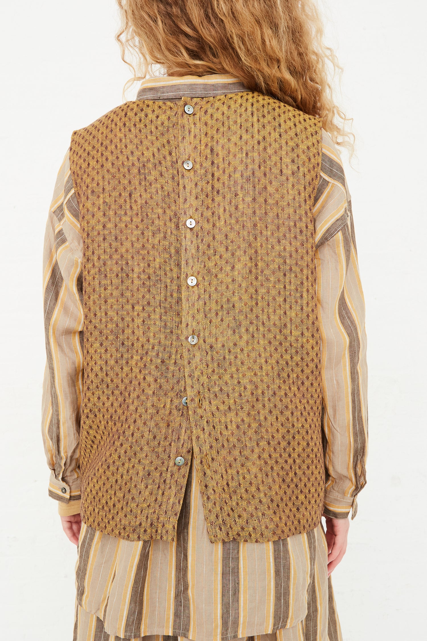 The back view of a model wearing an Ichi Antiquités Linen Dobby Pullover in Camel, available at Oroboro store in NYC.