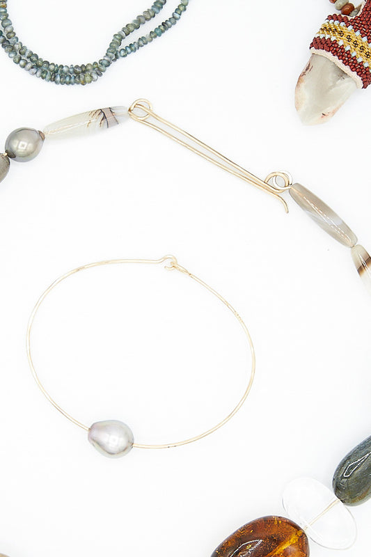 A collection of Mary MacGill 14K Cuff in Tahitian Silver Pearl wire necklaces, earrings, and bracelets with a focus on cuff bracelets and Tahitian Silver Pearl jewelry.