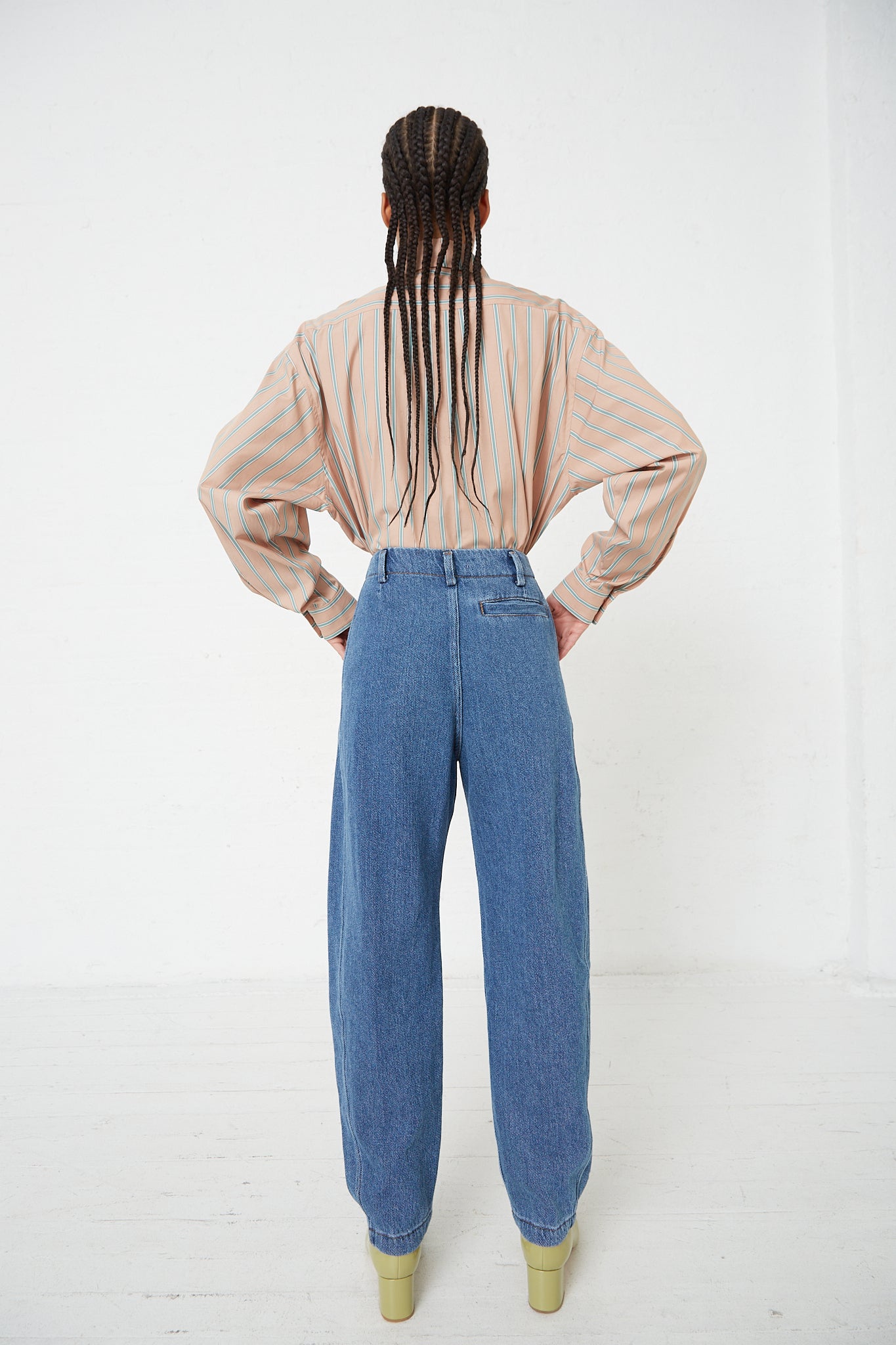 The back view of a woman wearing Rachel Comey's Denim Percy Pant in Indigo.