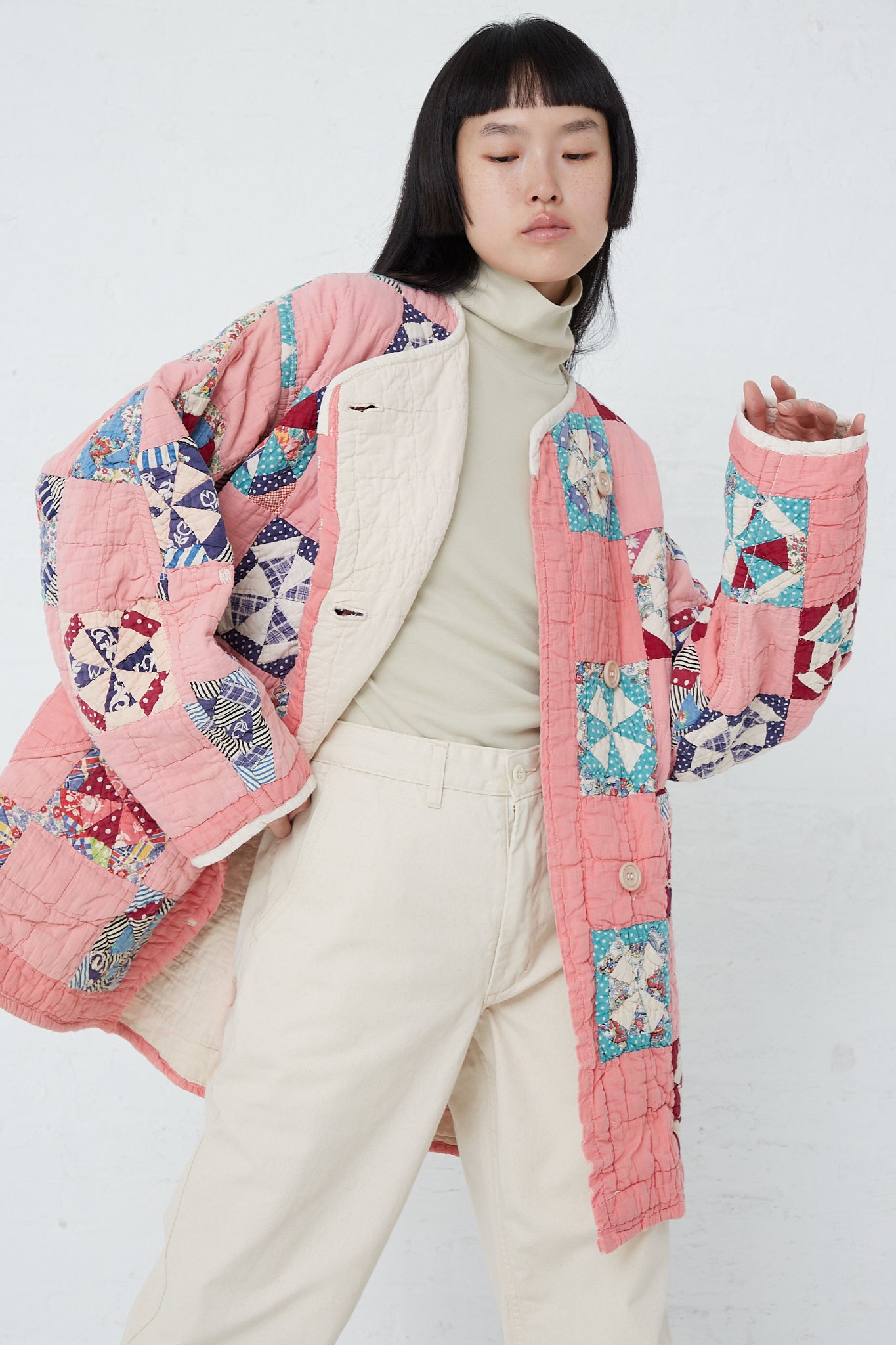 A woman wearing an As Ever Quilt Jacket in Pink. Front view.