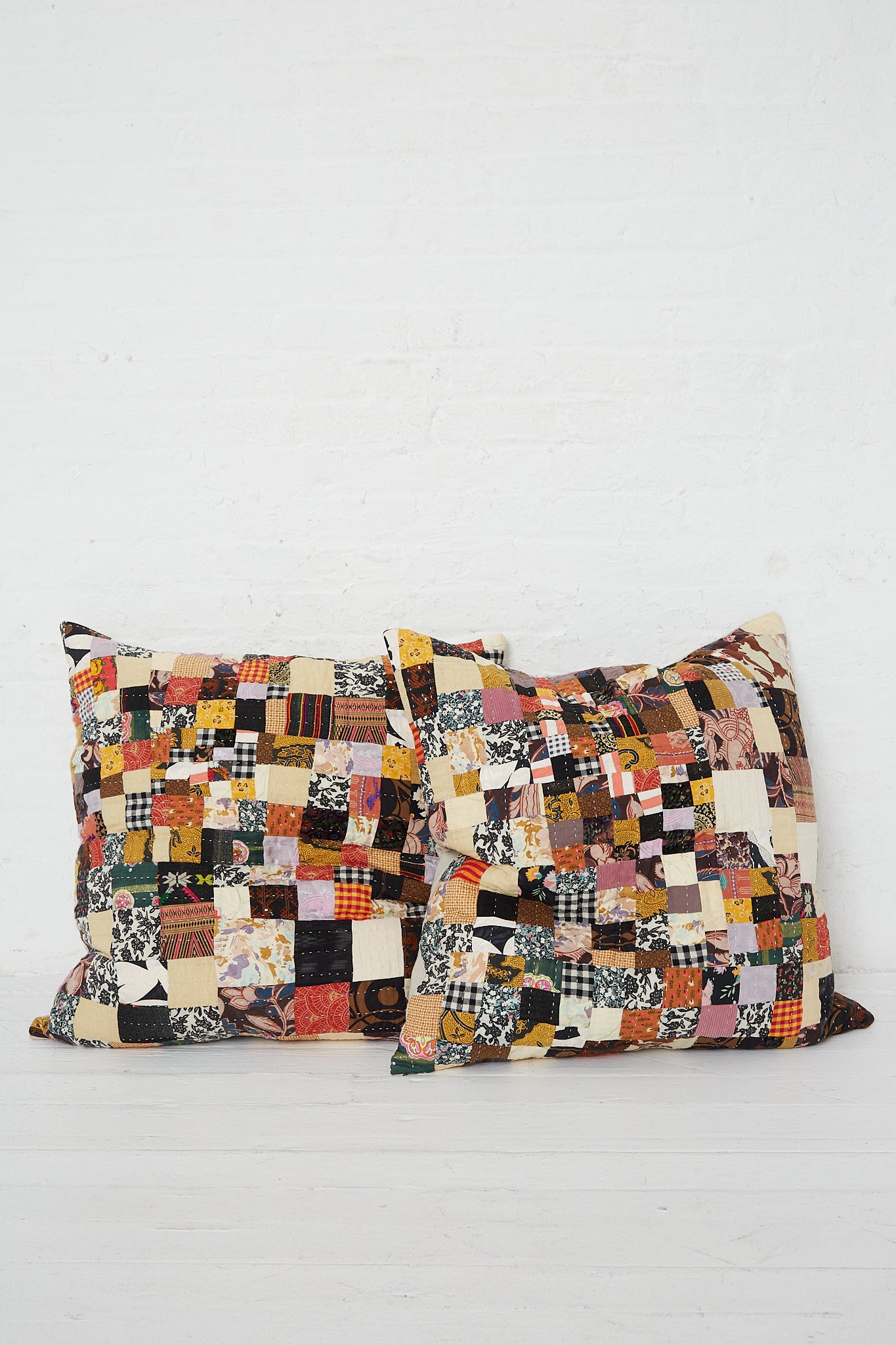 Two Counterpane antique patchwork pillows in Brown Multi I on a white background.