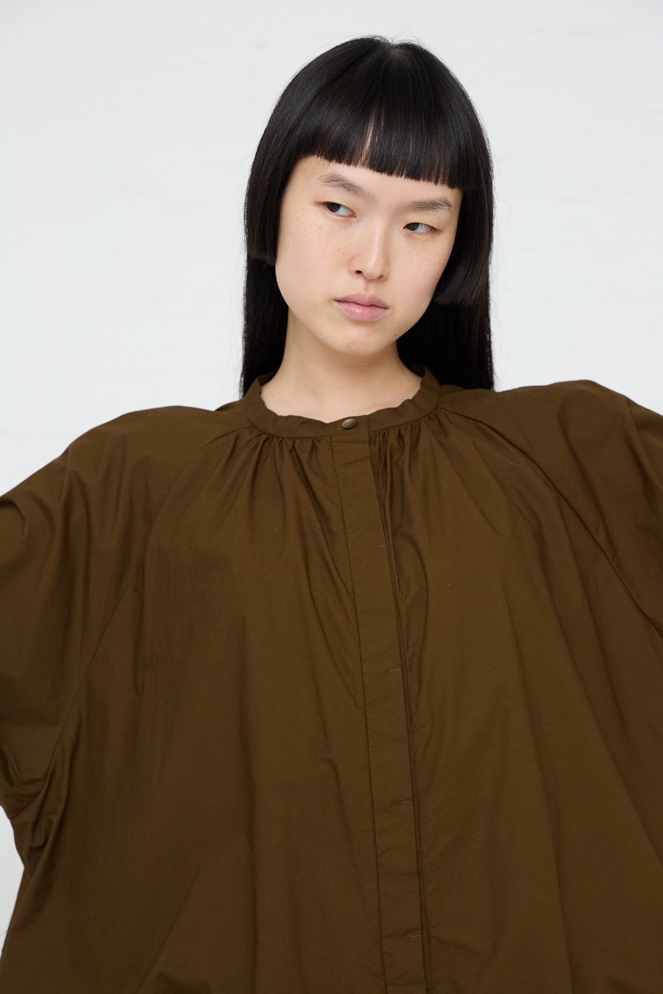 The model is wearing an Ichi Woven Cotton Shirt in Seal Brown. Up close.