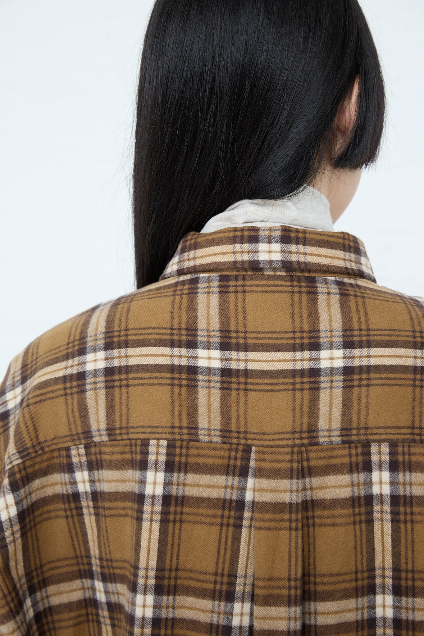 The back view of a woman wearing an Ichi Woven Cotton Dress in Camel. Up close.