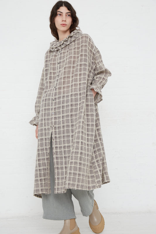 A woman wearing a Wool Check Frill Dress in Mocha by Ichi Antiquités.