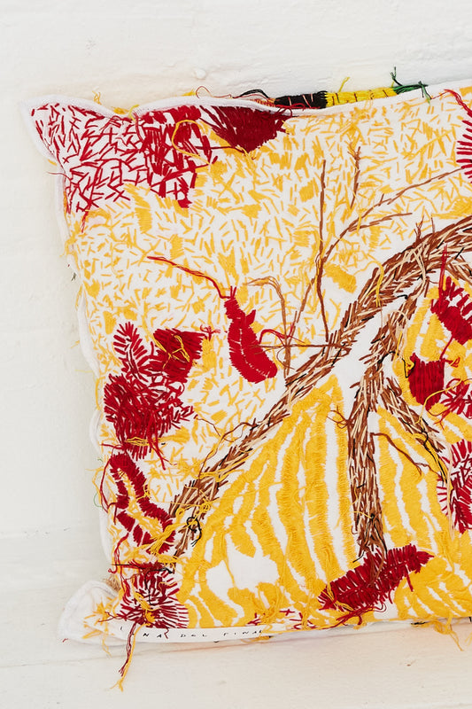 A yellow and red Hand Embroidered Harvest Topographic Cushion adorned with a tree motif, featuring exquisite hand embroidery by Luna Del Pinal.