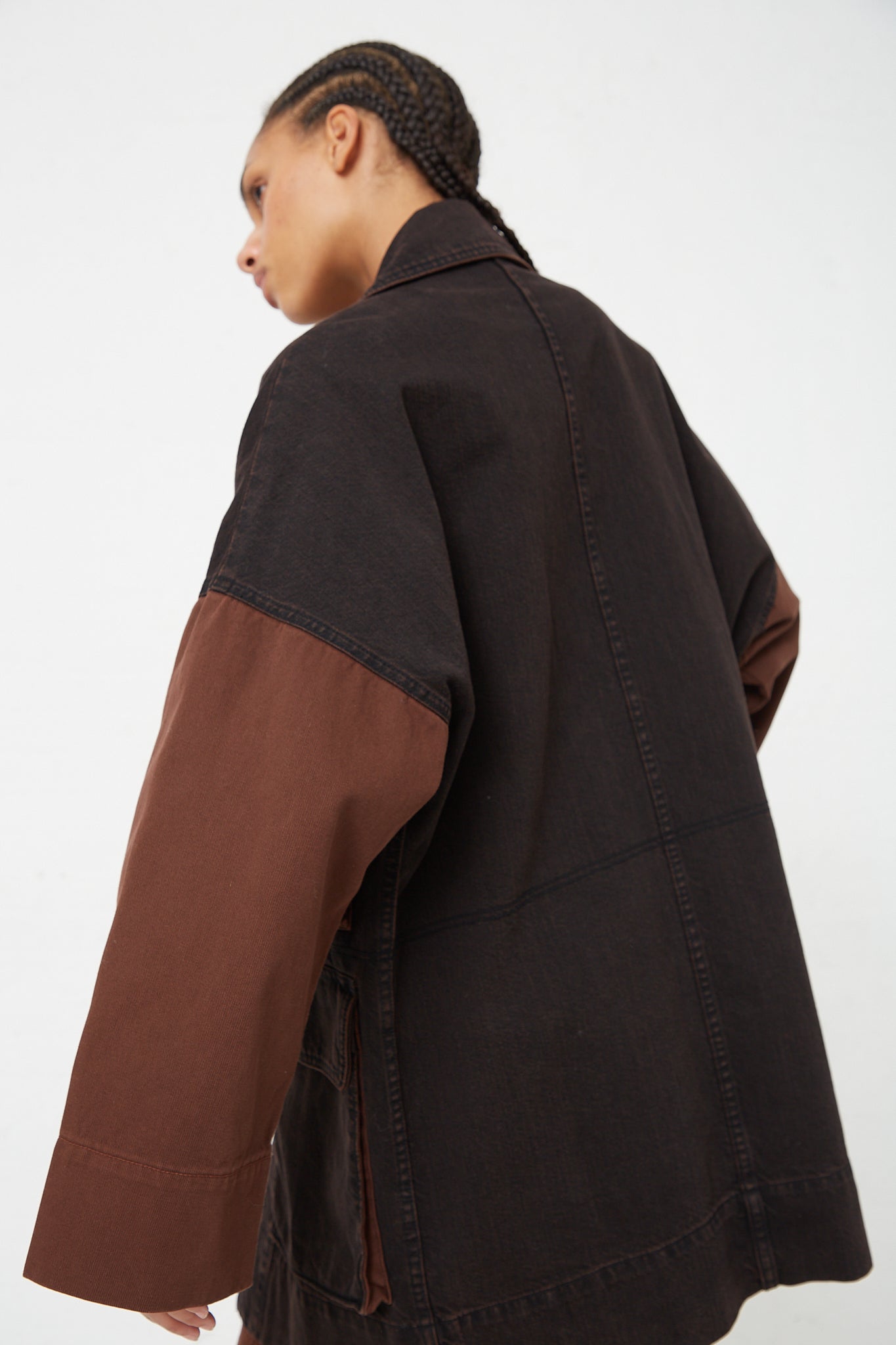 The back view of a woman wearing a Rachel Comey Denim Celeiro Jacket in Chestnut with snap closure.