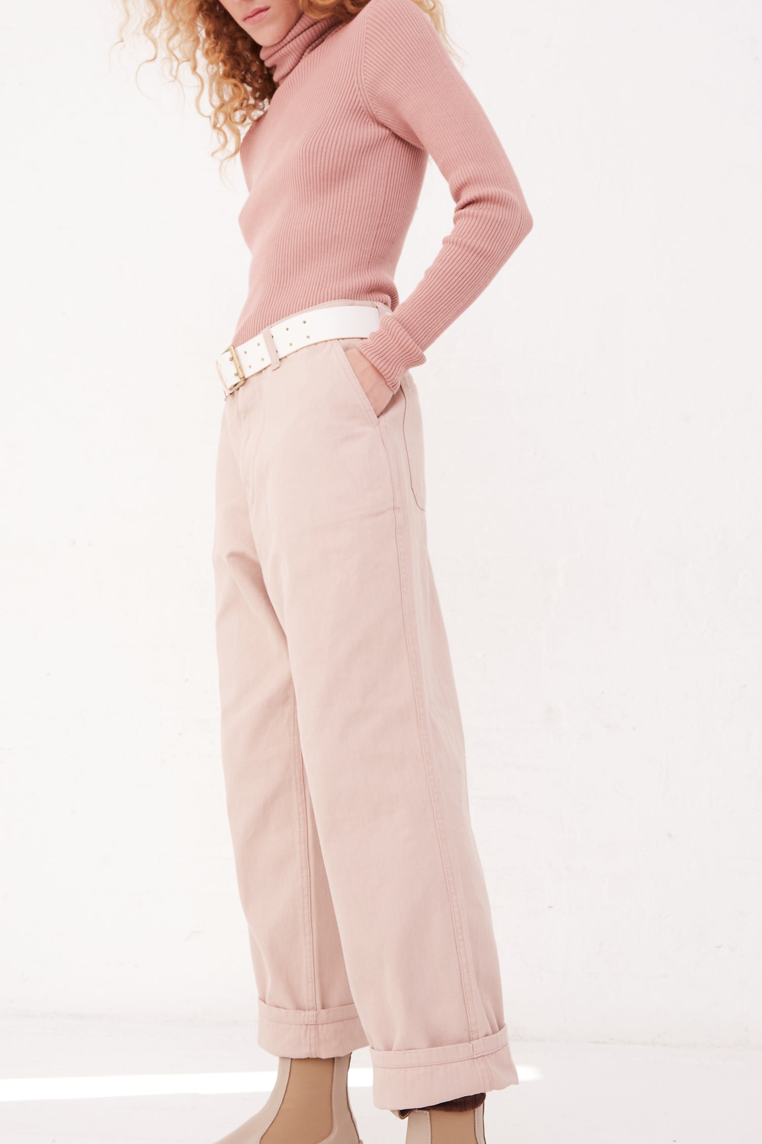 A model wearing Ichi Antiquités' Herringbone Pants in Pink and a relaxed fit pink long sleeve cotton shirt.