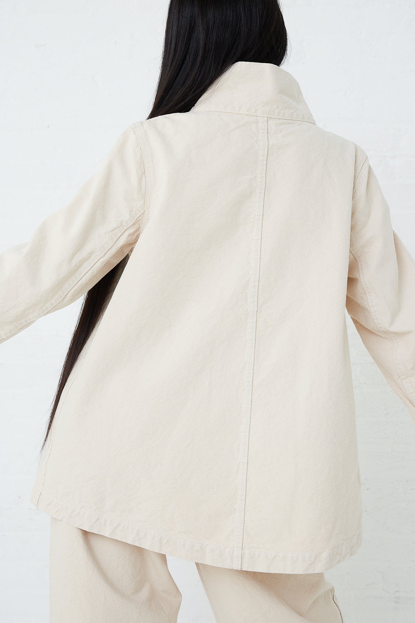 A woman wearing a Jesse Kamm Organic Canvas Deck Jacket in Natural.