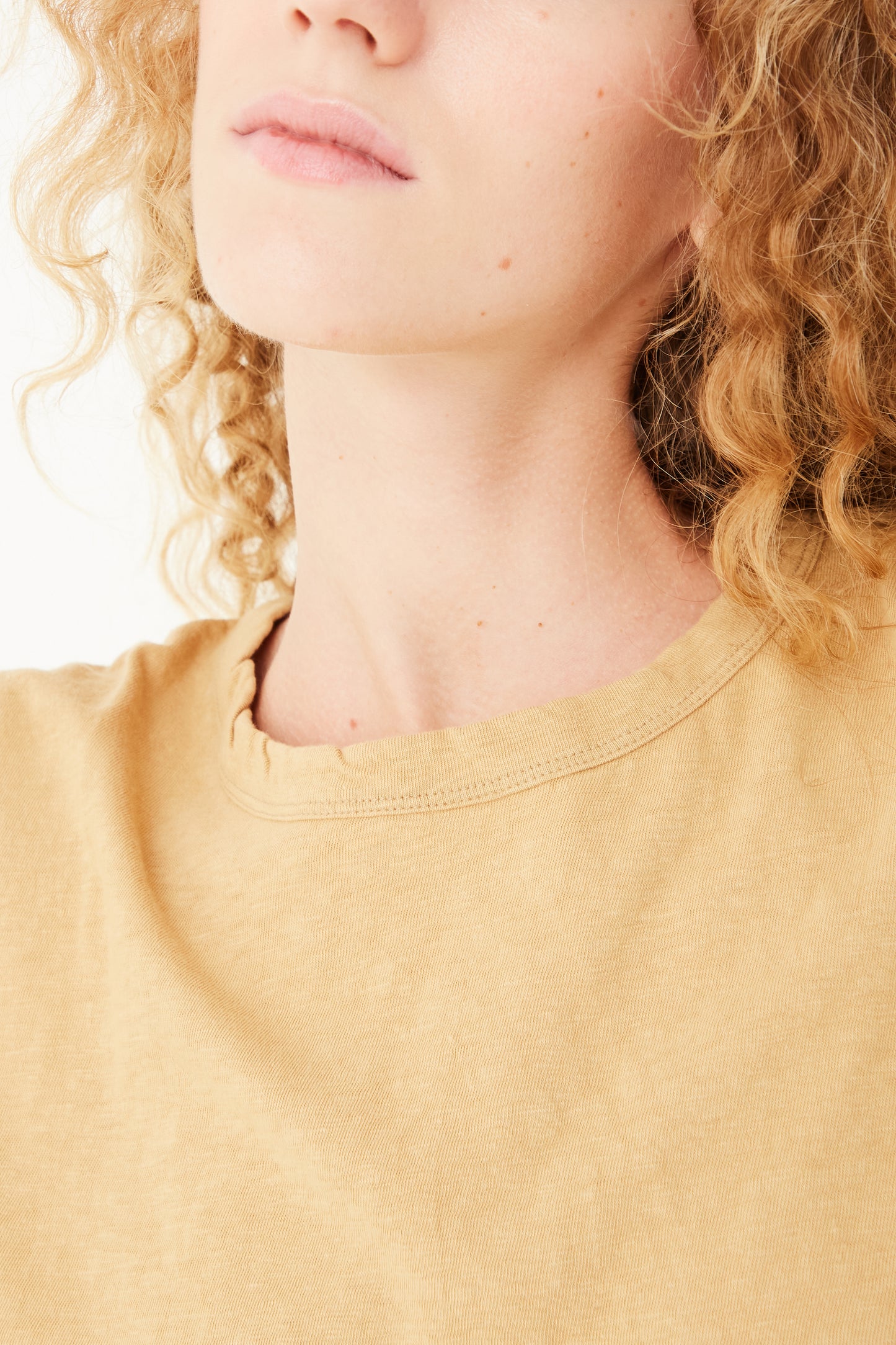 A model wearing an Ichi Antiquités Cotton Loose Pullover in Camel yellow t-shirt.