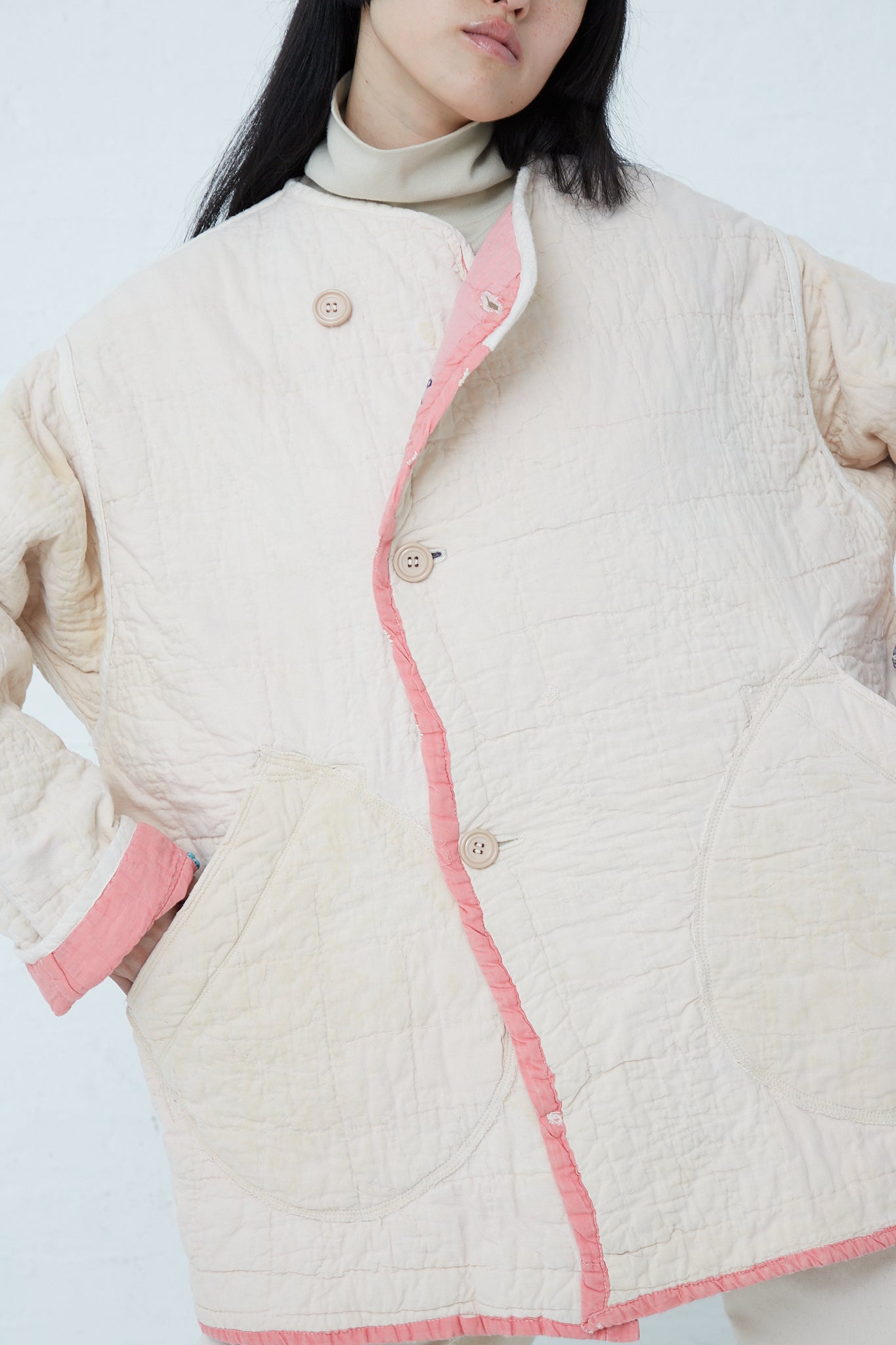 A woman wearing the As Ever Quilt Jacket in Pink. Reversed.