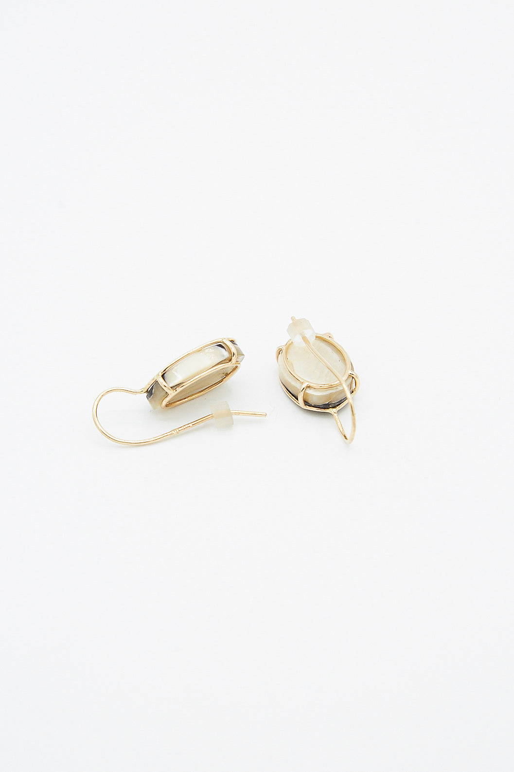 Handmade Mary MacGill 14K gold-plated earrings in Cowrie Shell design, beautifully displayed on a white surface. Back side view.