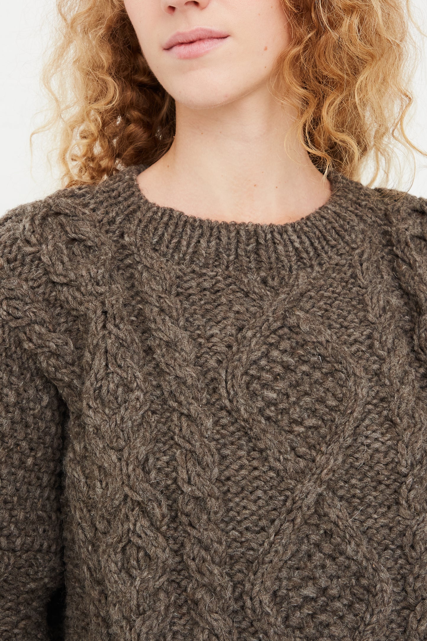 A woman wearing a Wool Hand-Knit Pullover in Mocha by Ichi Antiquités.