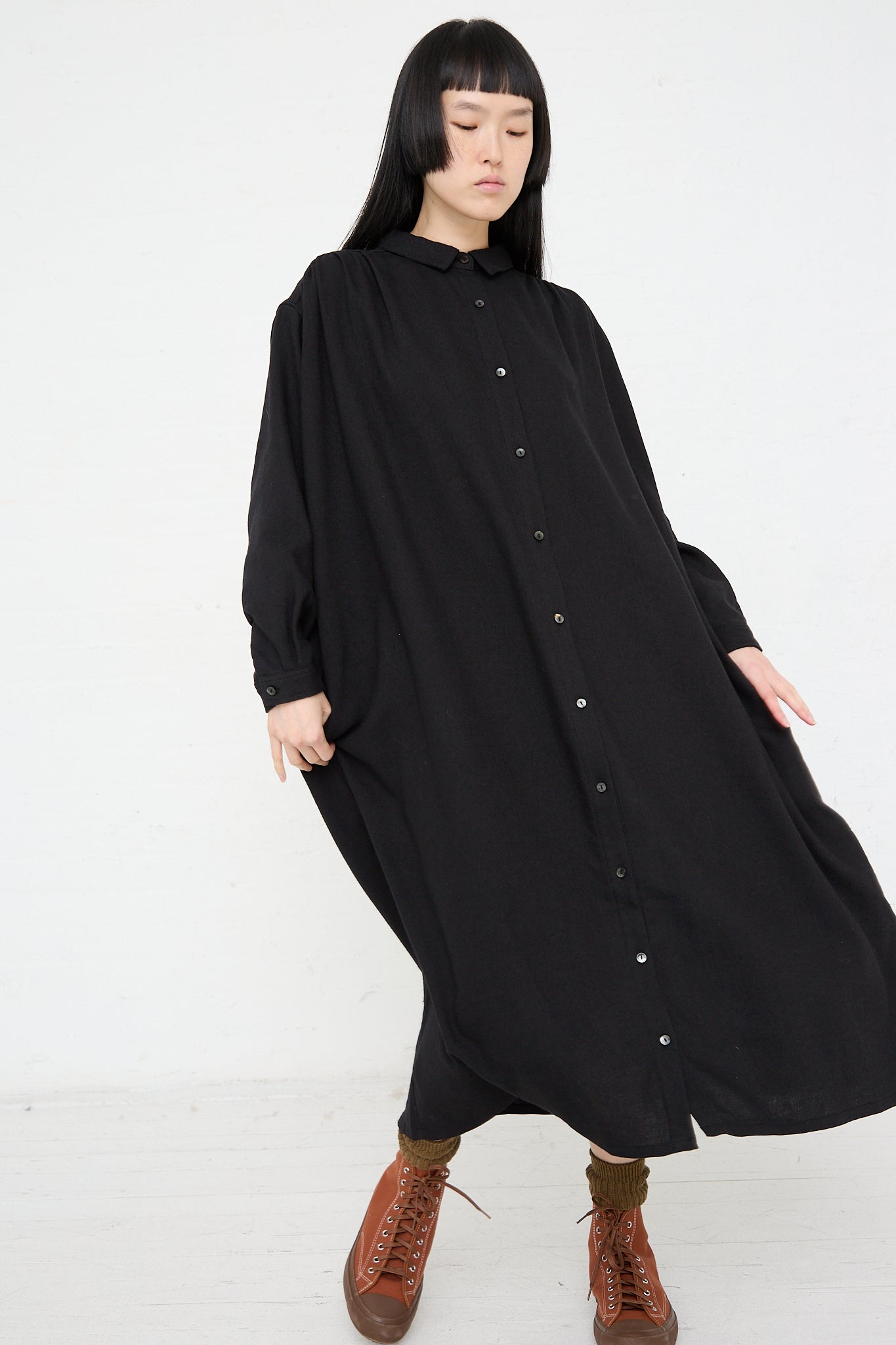 A woman wearing a long sleeve Ichi woven dress in black made of natural fibers.