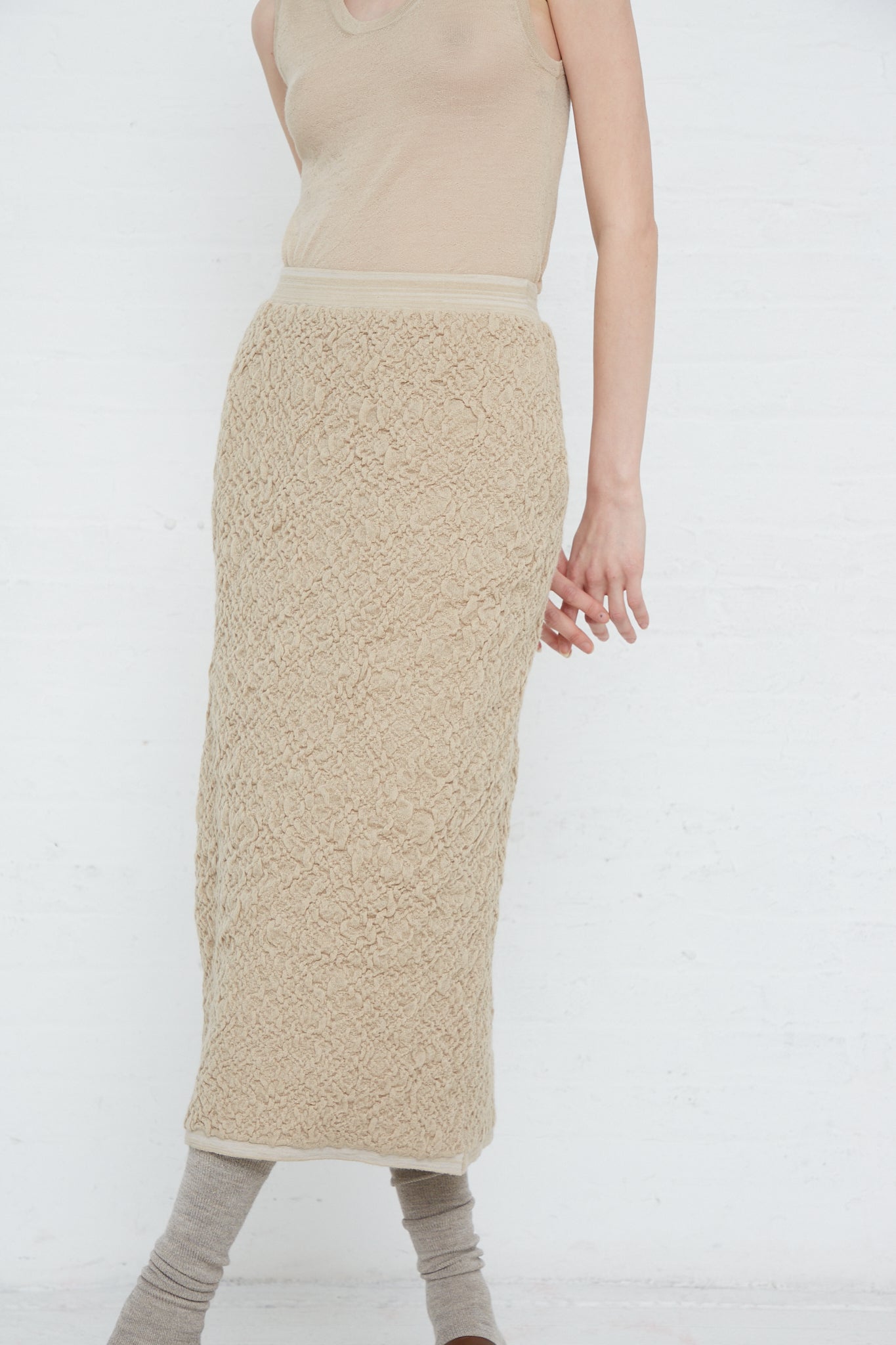 A woman wearing a Baby Alpaca Gauze Skirt in Antique by Lauren Manoogian. Front view and full length view.