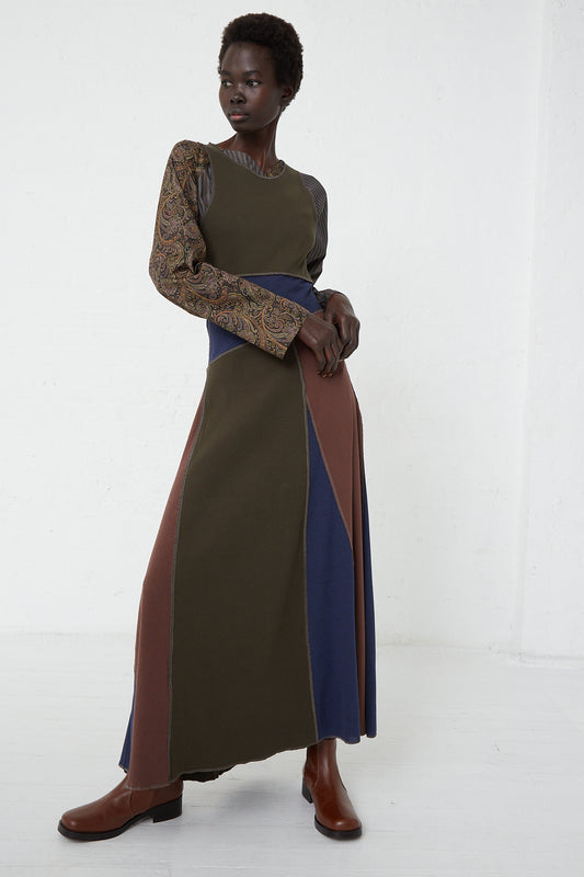 The model is wearing a green and blue SC103 Cotton Rib Crest Dress in Silt.