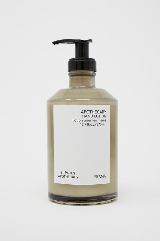 A bottle of Frama Hand Lotion in Apothecary 375ml with a black cap on a white background. The lotion moisturizes and contains natural ingredients.