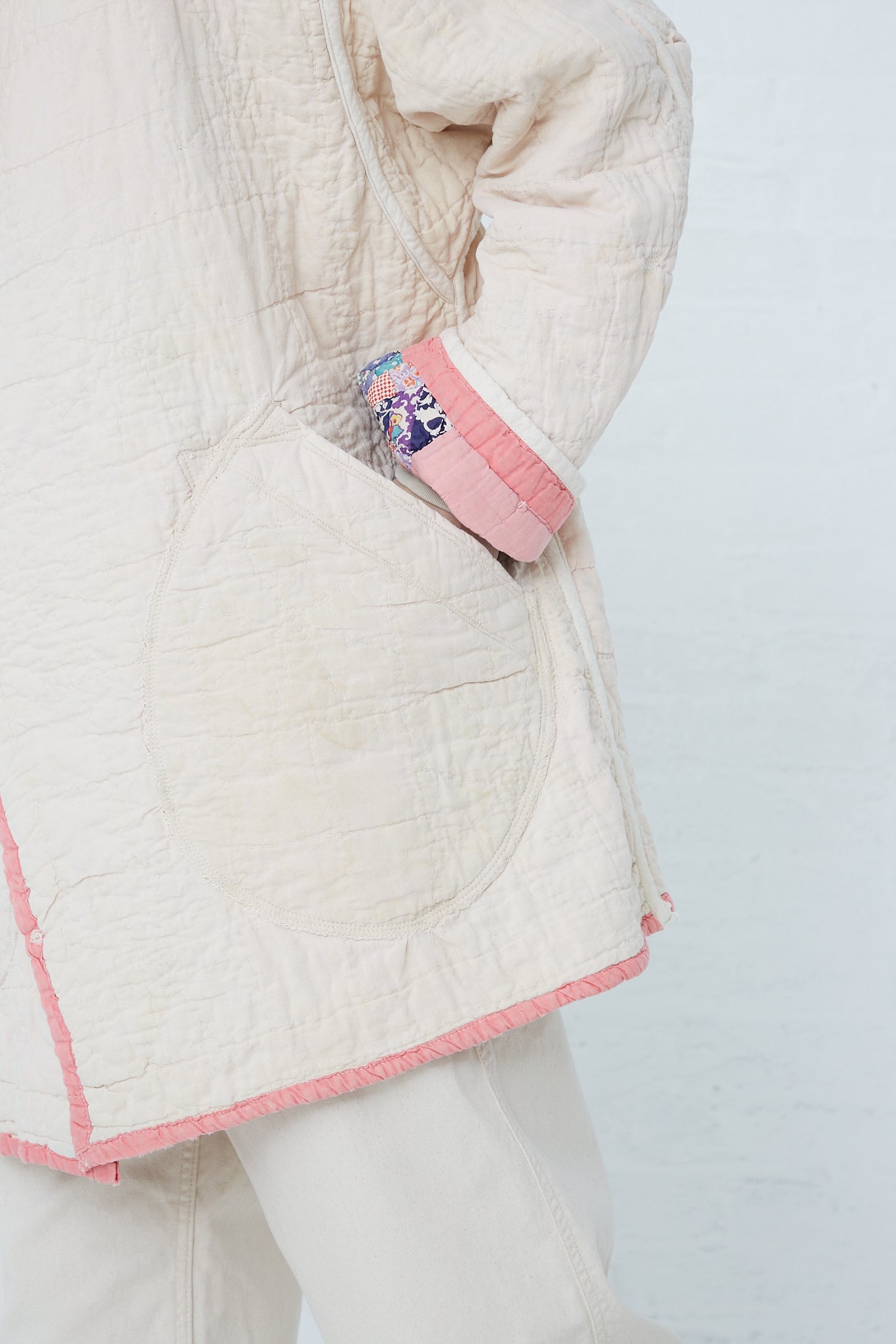 A woman wearing a As Ever Quilt Jacket in Pink. Up close.