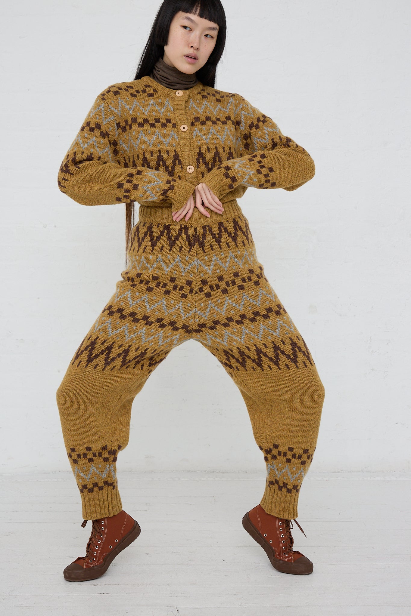 A woman in an Ichi multi-color Knit Pant in Camel is posing for the camera.