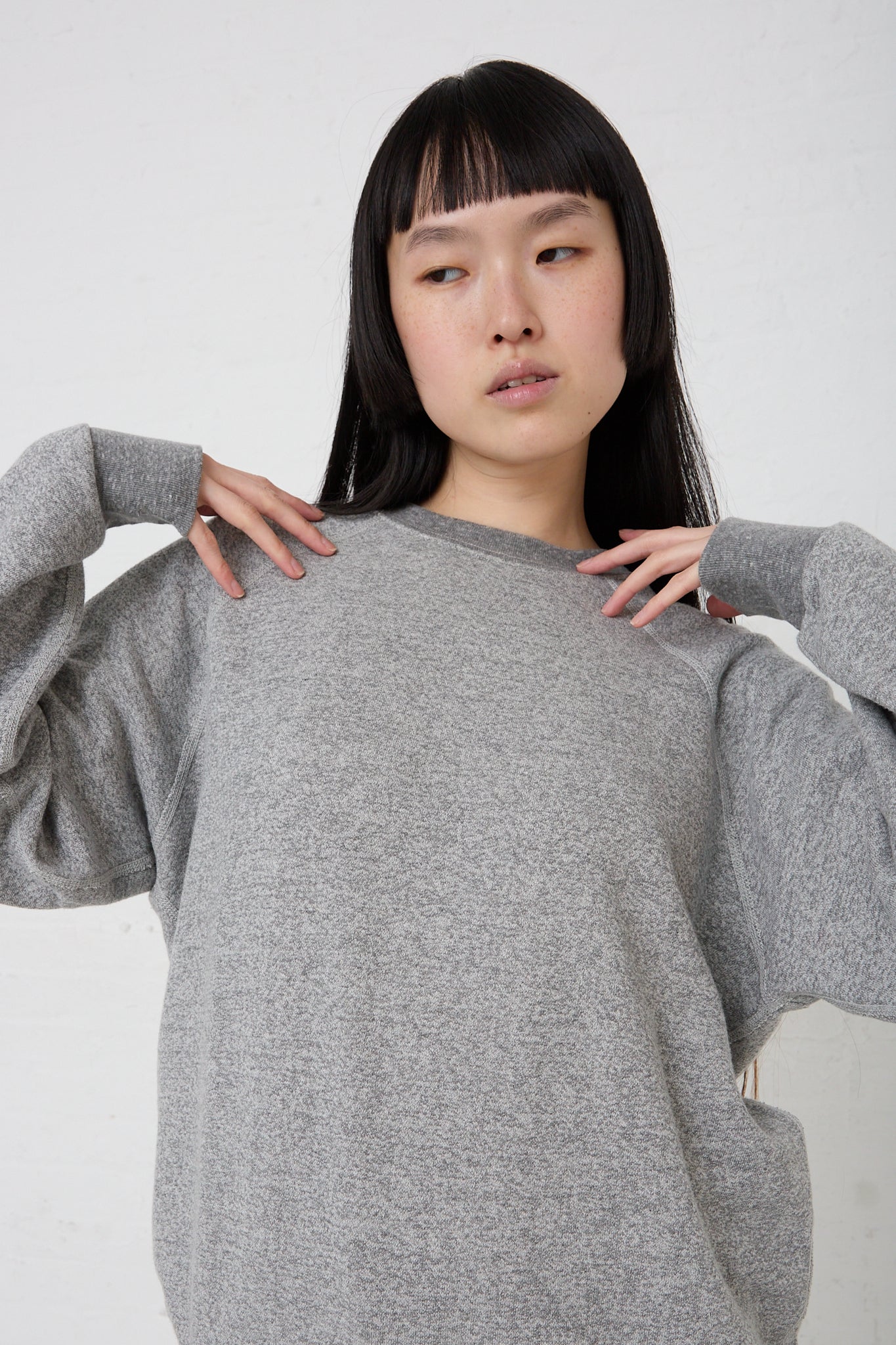 The model is wearing a French Terry Sweatshirt in Heather Grey from B Sides. Front view.