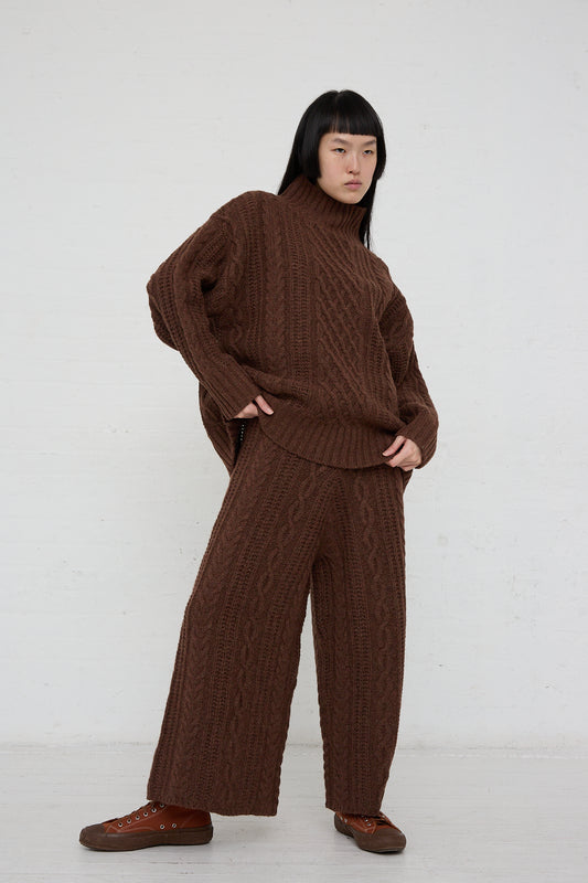 A woman wearing a patterned wool blend sweater and Ichi Knit Pant in Brown wide leg pants.
