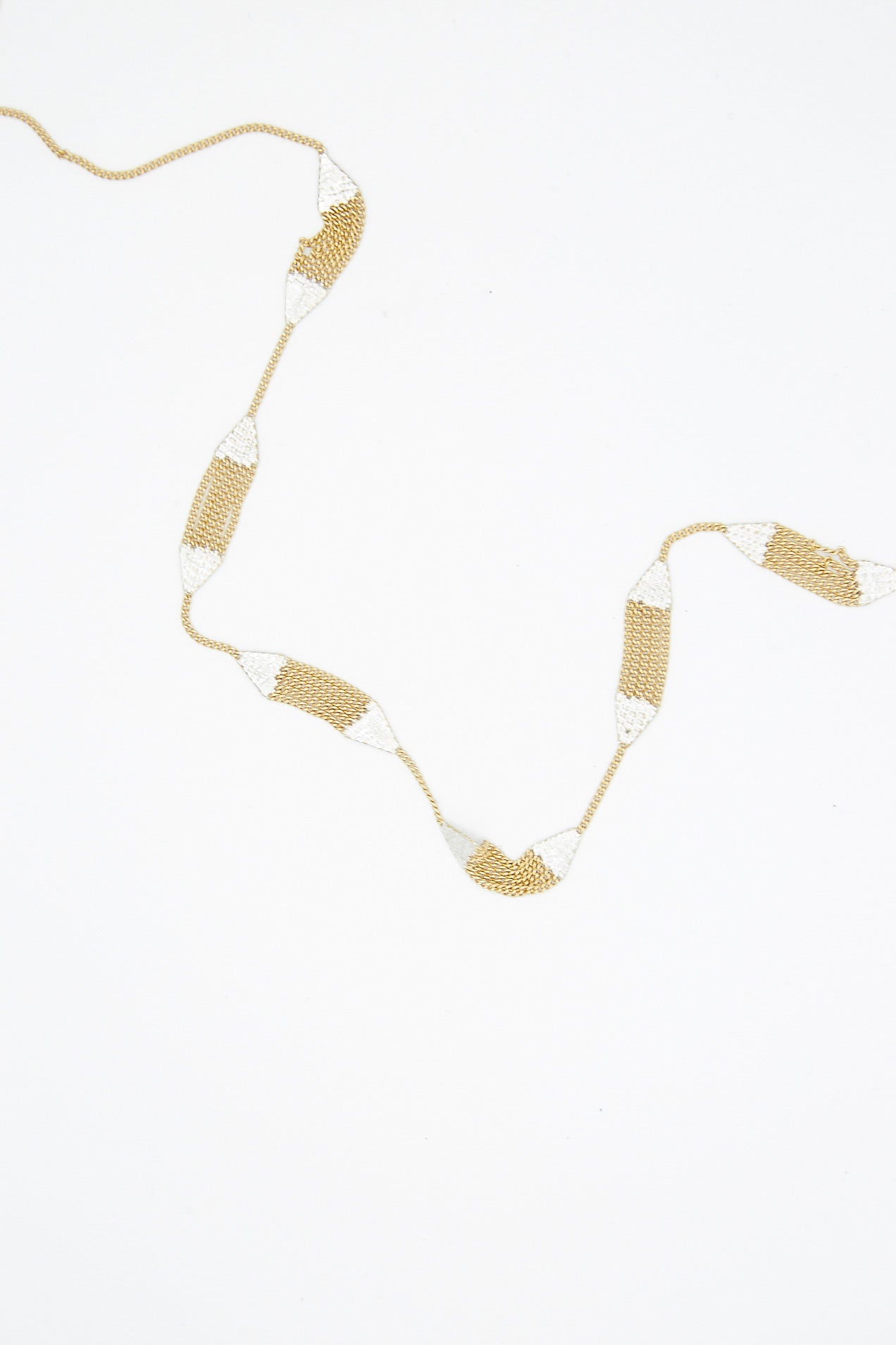 A handmade Hannah Keefe Minnow Necklace in Brass Chain and Silver Solder, featuring geometric forms and made in California.