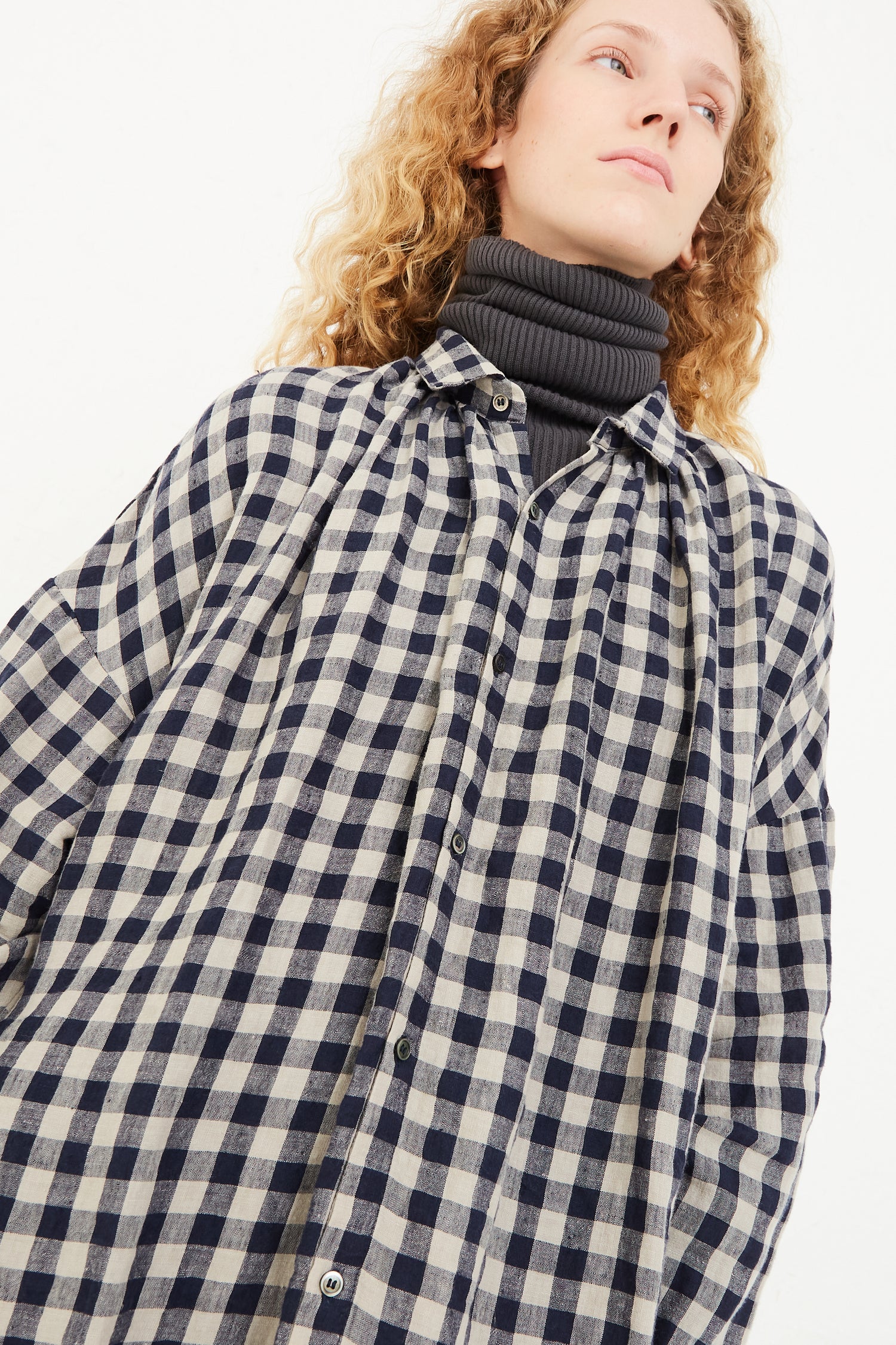 The model is wearing the Azumadaki Linen Gingham Dress in Beige by Ichi Antiquités.