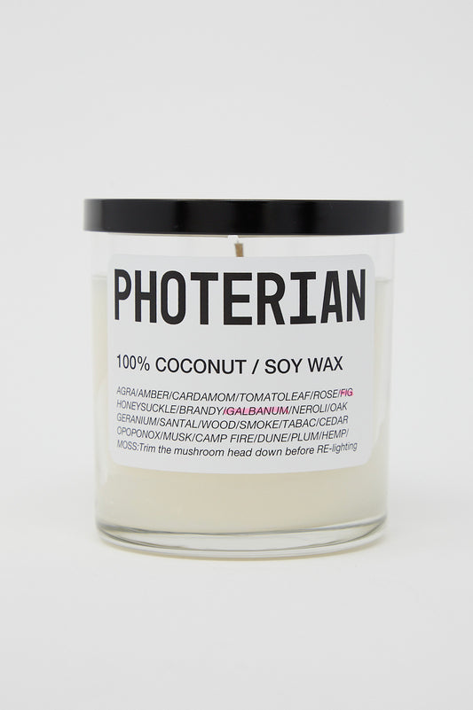 A jar with the brand name Photerian on it, containing a Votive Coconut Soy Candle in Fig.