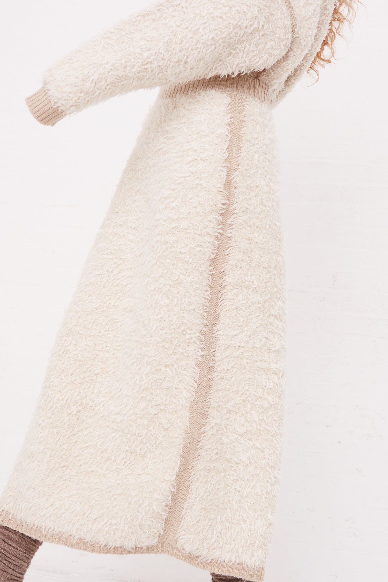 The model is wearing a Sherpa Skirt in Raw White made by Lauren Manoogian.