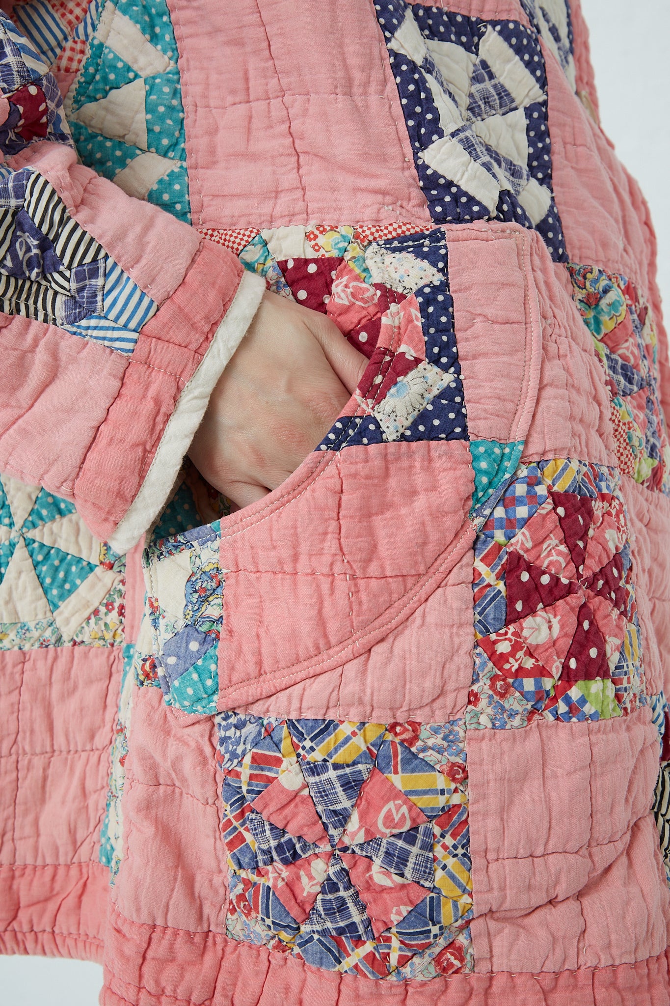 A woman wearing an As Ever Quilt Jacket in Pink. Up close view.